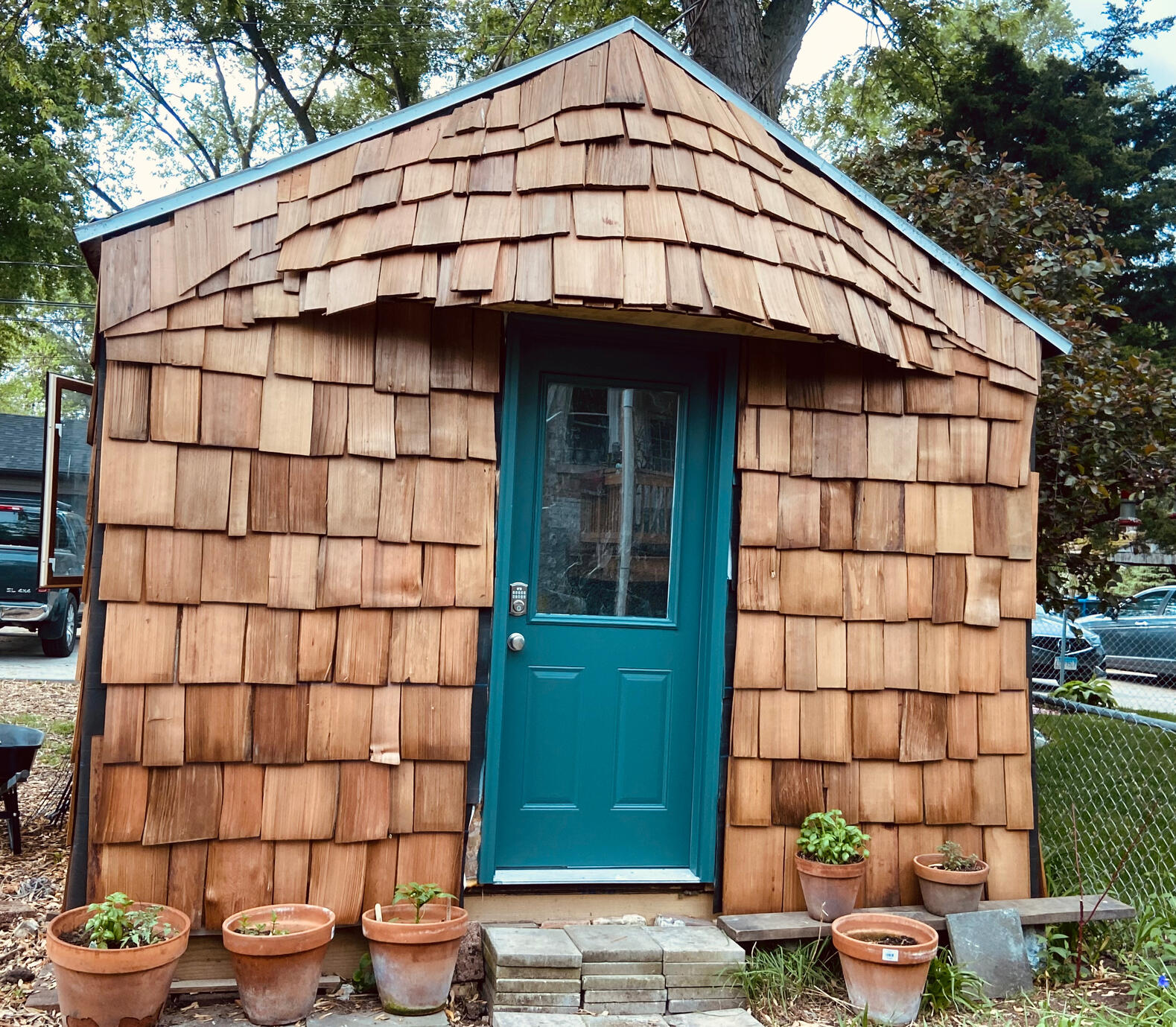 Backyard shed in chicago with rustic cedar shake siding. she shed, writing shed, art studio, ADU, garden shed, cedar shakes, shed siding, outbuilding, natural building materials, backyard